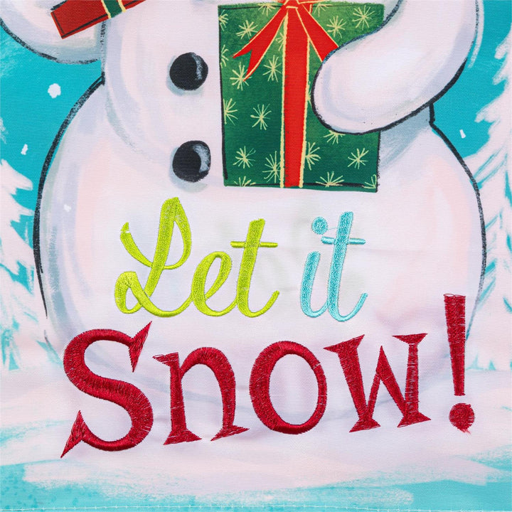 Snowman garden flag displayed outdoors by a porch