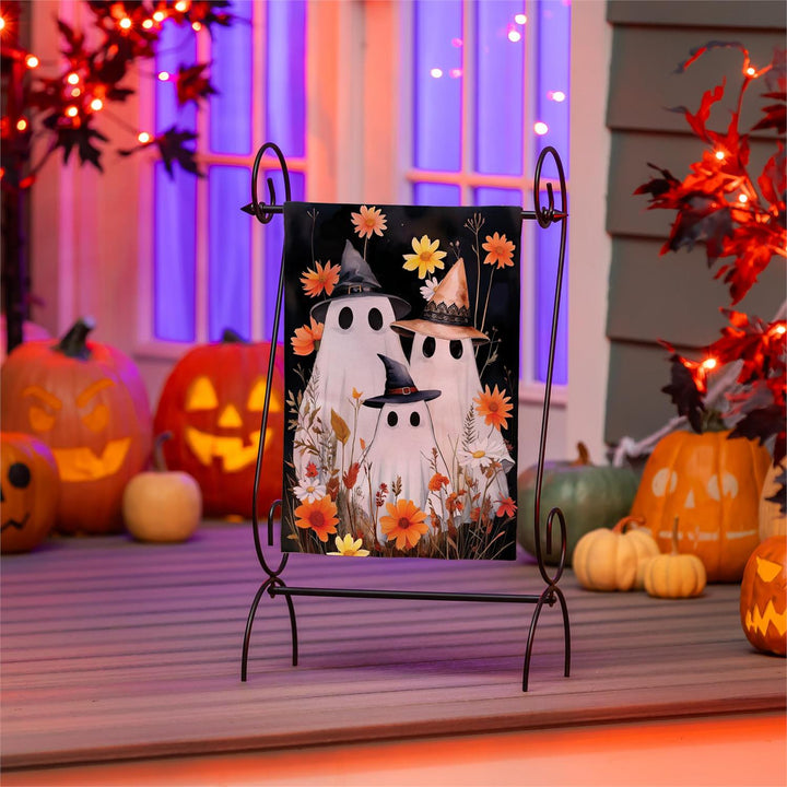 Close-up of witch-hat ghost and autumn flowers on textured polyester burlap flag