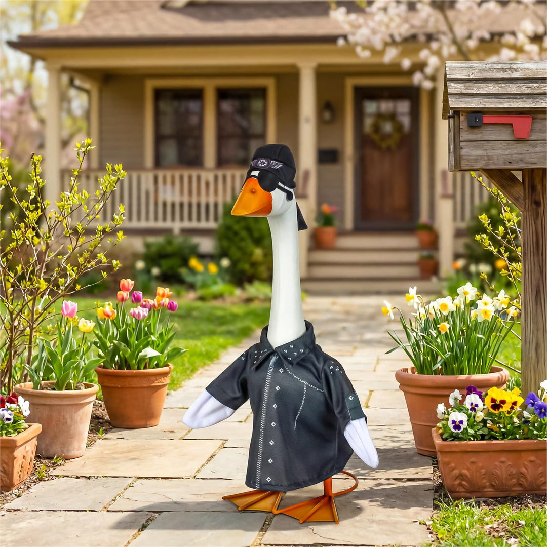 Biker porch goose outfit displayed on a goose beside a flower-lined front walkway