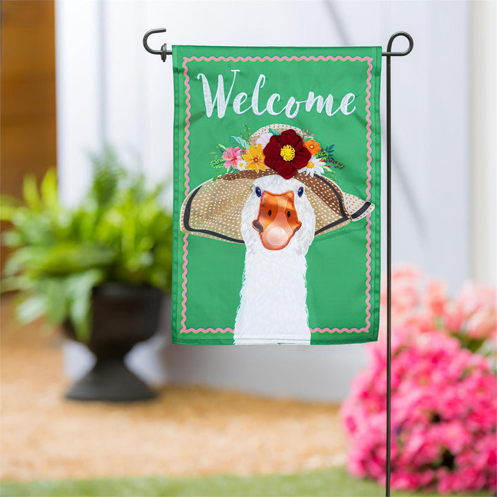 Flowery Goose Welcome Garden Flag displayed on a garden flag pole outside a home entrance