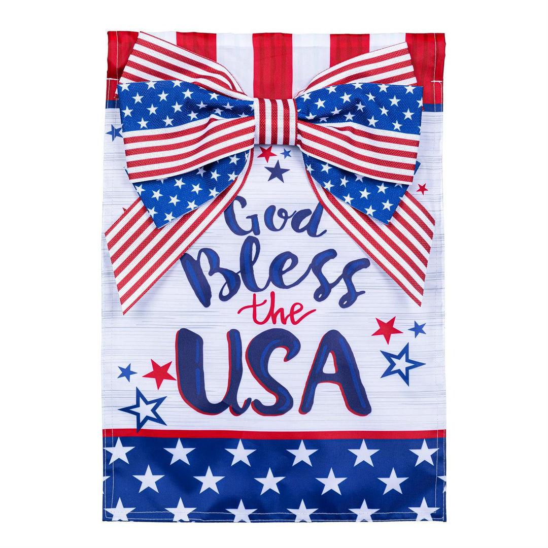 God Bless The USA Bow Garden Flag - product flat lay showing patriotic flag with large appliqued bow, navy stars, and God Bless the USA text