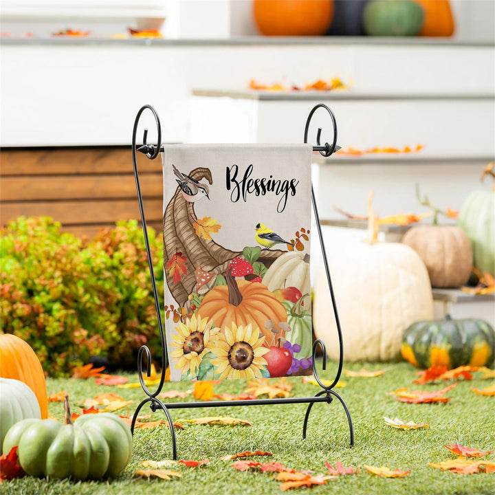 Grateful Cornucopia garden flag displayed among pumpkins and autumn leaves