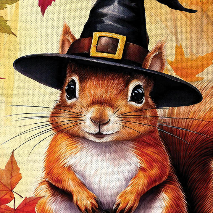 Halloween squirrel garden flag artwork with black witch hat, smiling jack-o-lantern, fall leaves and acorns