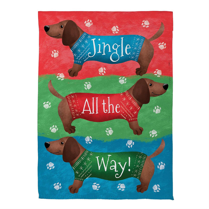 Jingle All the Way garden flag with three dachshunds in festive sweaters and paw prints