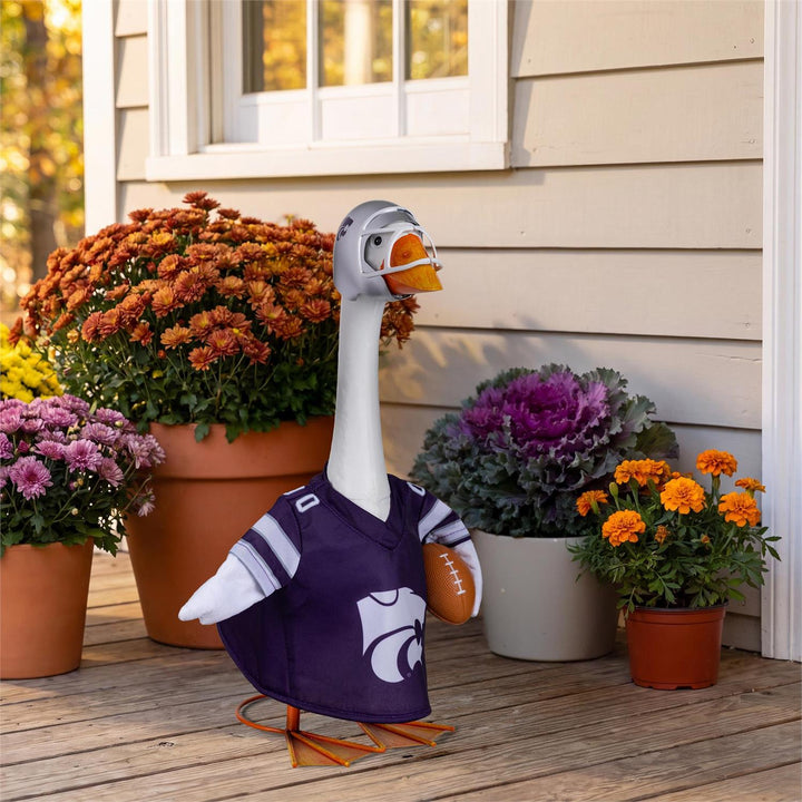 Kansas State football outfit modeled on a decorative porch goose beside autumn flowers; goose not included