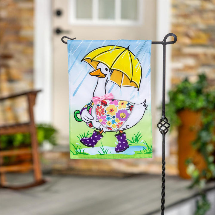 Rina The Rainy Day Goose Garden Flag displayed on a garden flag pole outside a home entrance