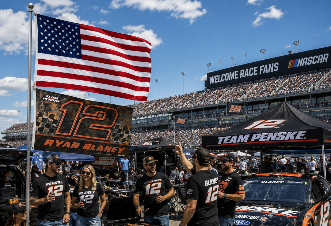 Ryan Blaney Camo 3x5 Flag flying on a flagpole at a NASCAR tailgate with fans wearing #12 Team Penske gear in front of a packed race stadium
