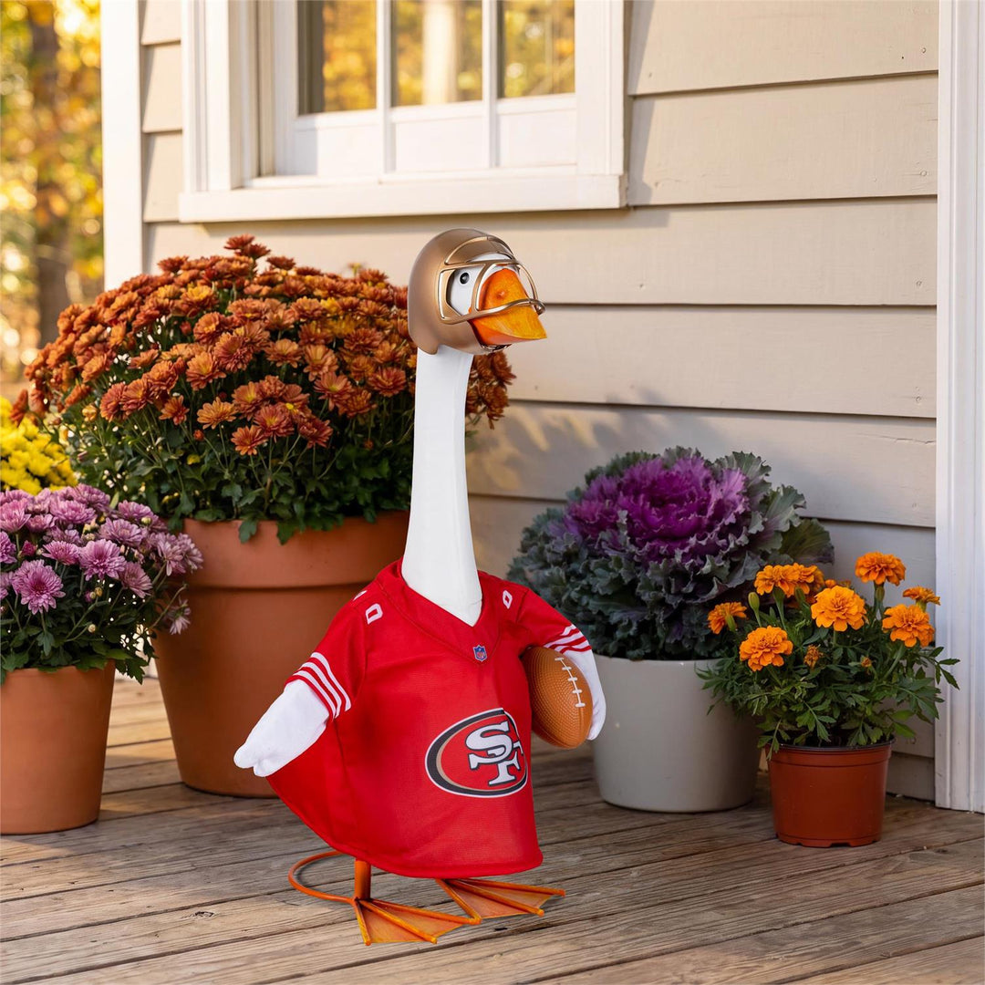 Front of licensed San Francisco 49ers NFL porch goose outfit with red SF logo jersey, gold helmet and football accent