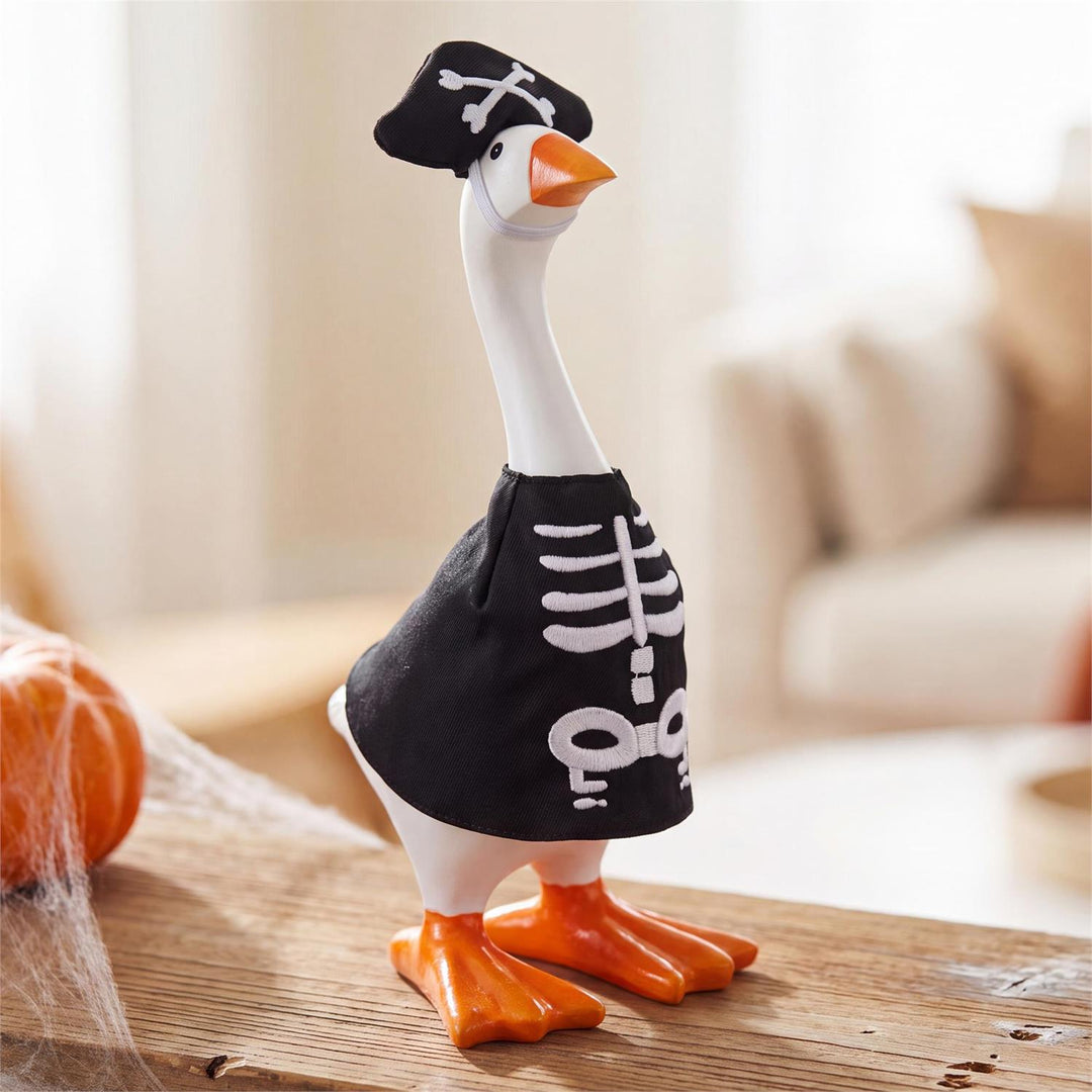 Desktop goose modeling black-and-white skeleton costume in a Halloween tabletop display