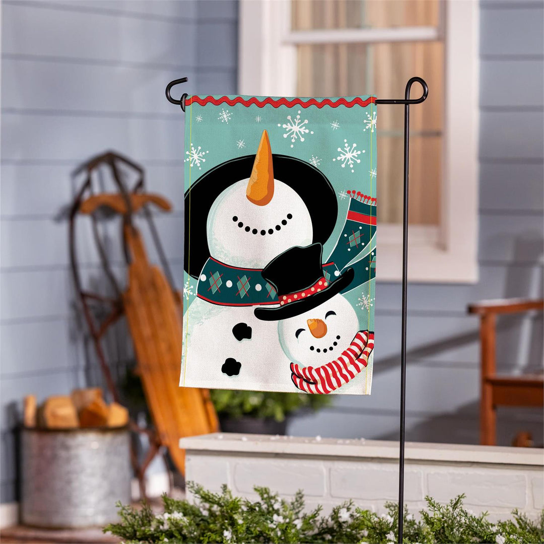 Snowman Pair flag specifications showing double-layer polyester burlap and approximately 2-inch pole sleeve
