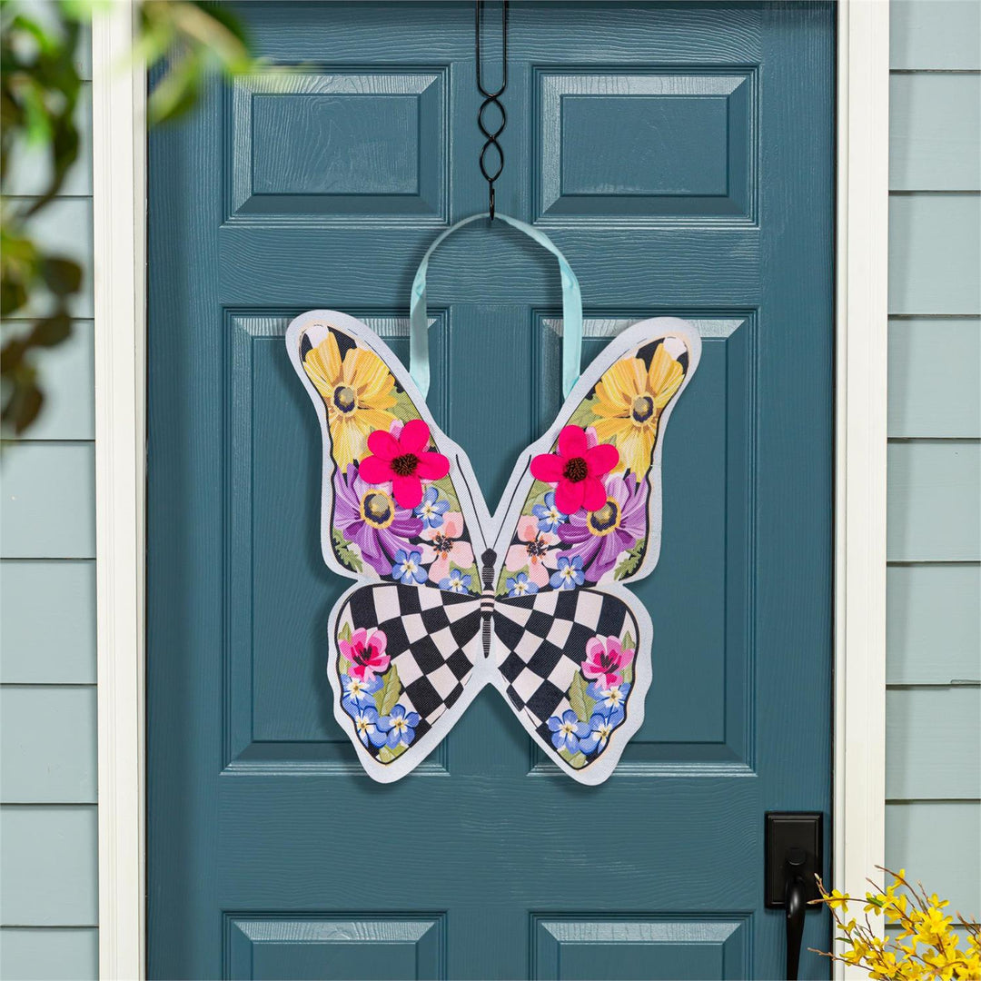 Summer Courtly Check Butterfly Door Decor hanging on a teal front door showing full butterfly display with vibrant floral upper wings and bold check lower wings