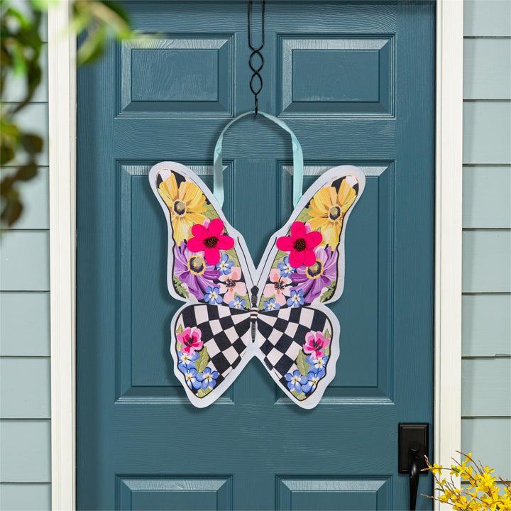 Summer Courtly Check Butterfly Door Decor hanging on a teal front door showing full butterfly display with vibrant floral upper wings and bold check lower wings