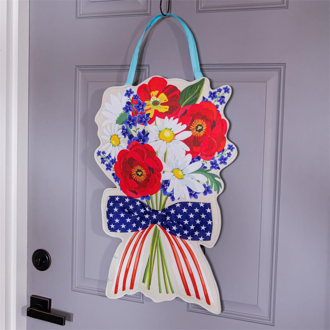 Summer Daisy Bow Bouquet Door Decor - patriotic side displayed hanging on a grey front door